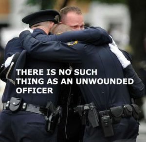 Police group hug - Unwounded officer- United Police Fund